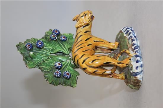 An early 19th century Staffordshire pearlware figure of an arched tiger, 13.5cm, damages